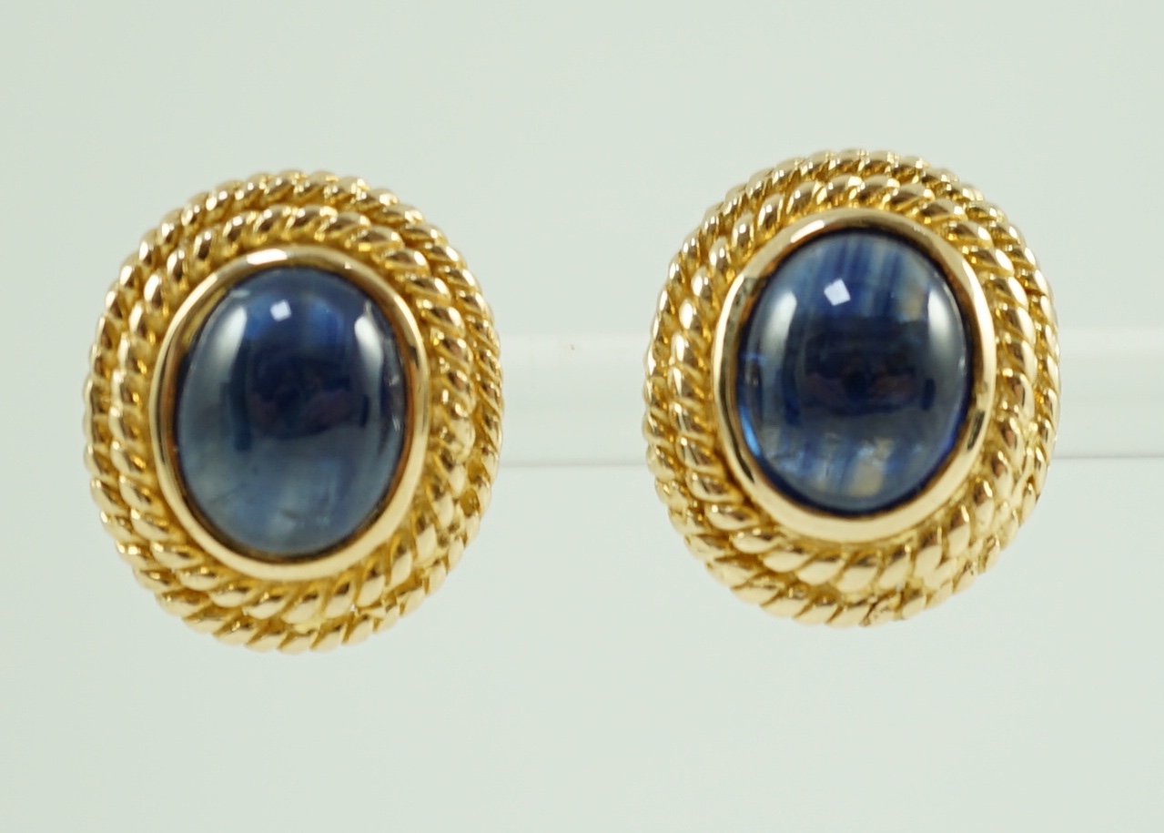 A 20th century pair of gold and cabochon sapphire set oval earrings